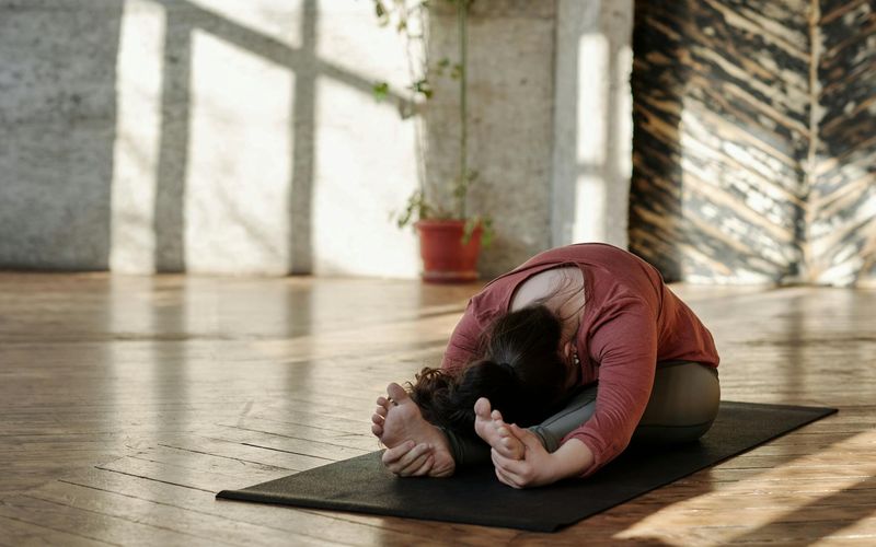 Yoga mat and accessories in a peaceful sunlit room.